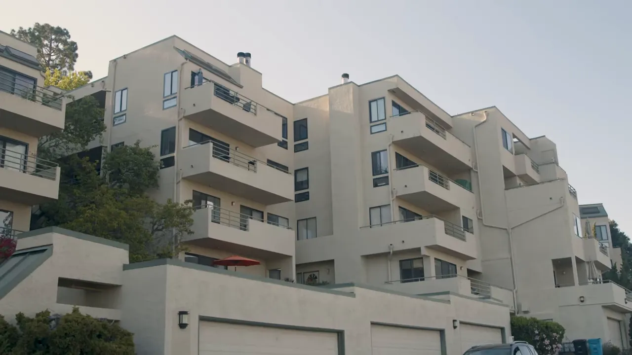 Exterior view of a multi-story condo building with balconies