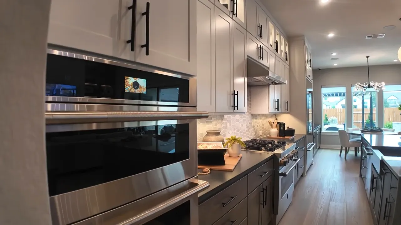 Kitchen with built in double ovens and six burner cooktop