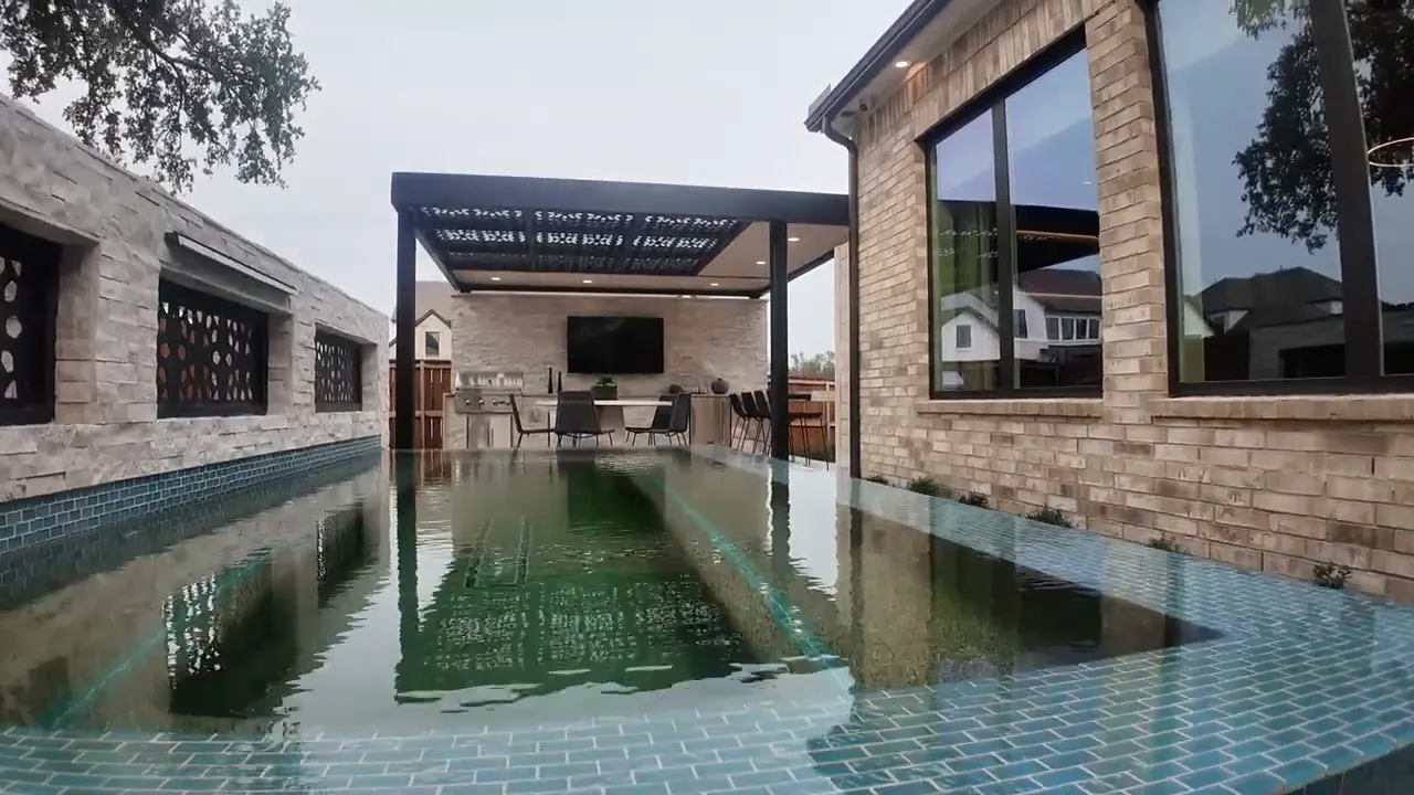 Long narrow plunge pool between outdoor living areas