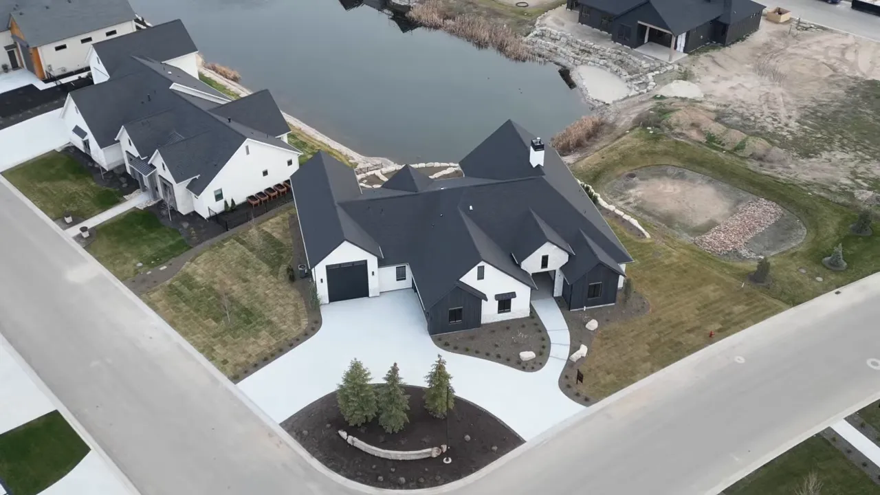 Aerial view of a large RV-friendly home beside a pond near Boise, Idaho