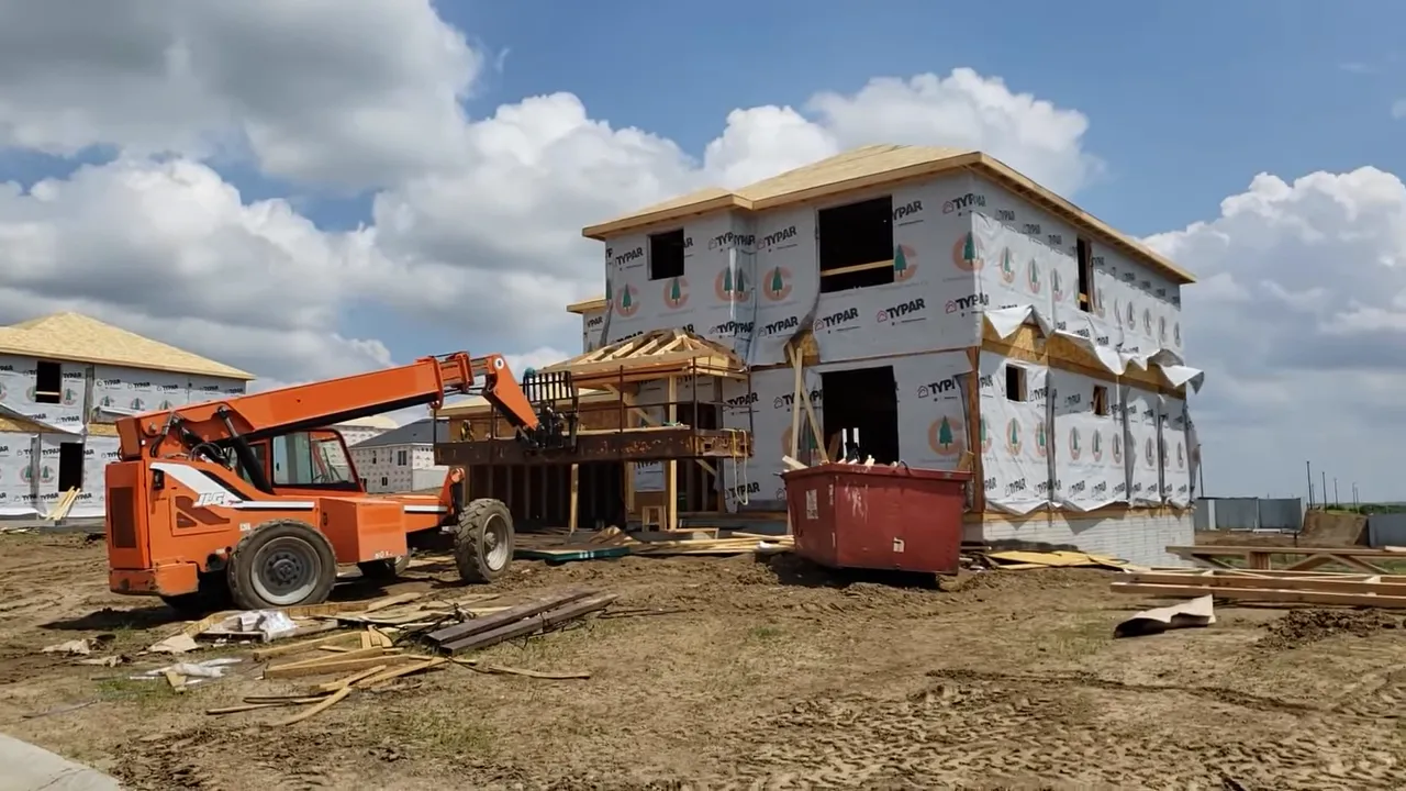construction site with large DR Horton Americas Builder logo across the frame