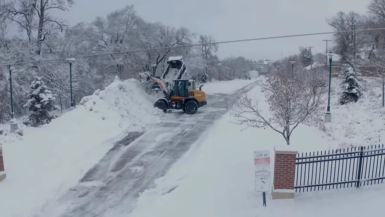 snow covered Omaha neighborhood with a road running through the middle during winter conditions