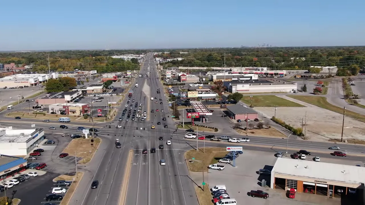 Aerial view of a busy Indianapolis-area road with surrounding shops and traffic