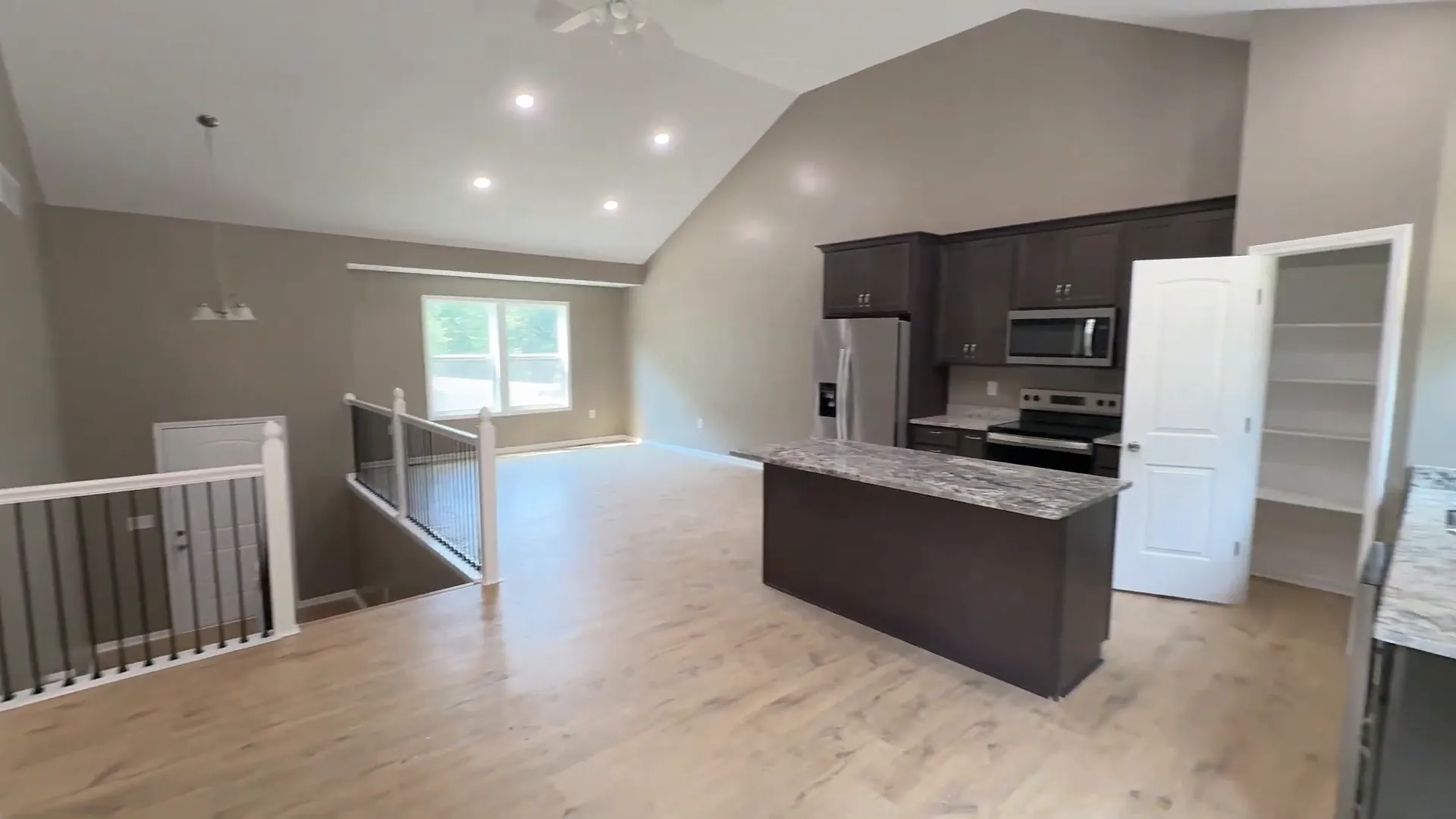 Open floor plan showing kitchen flowing into living area