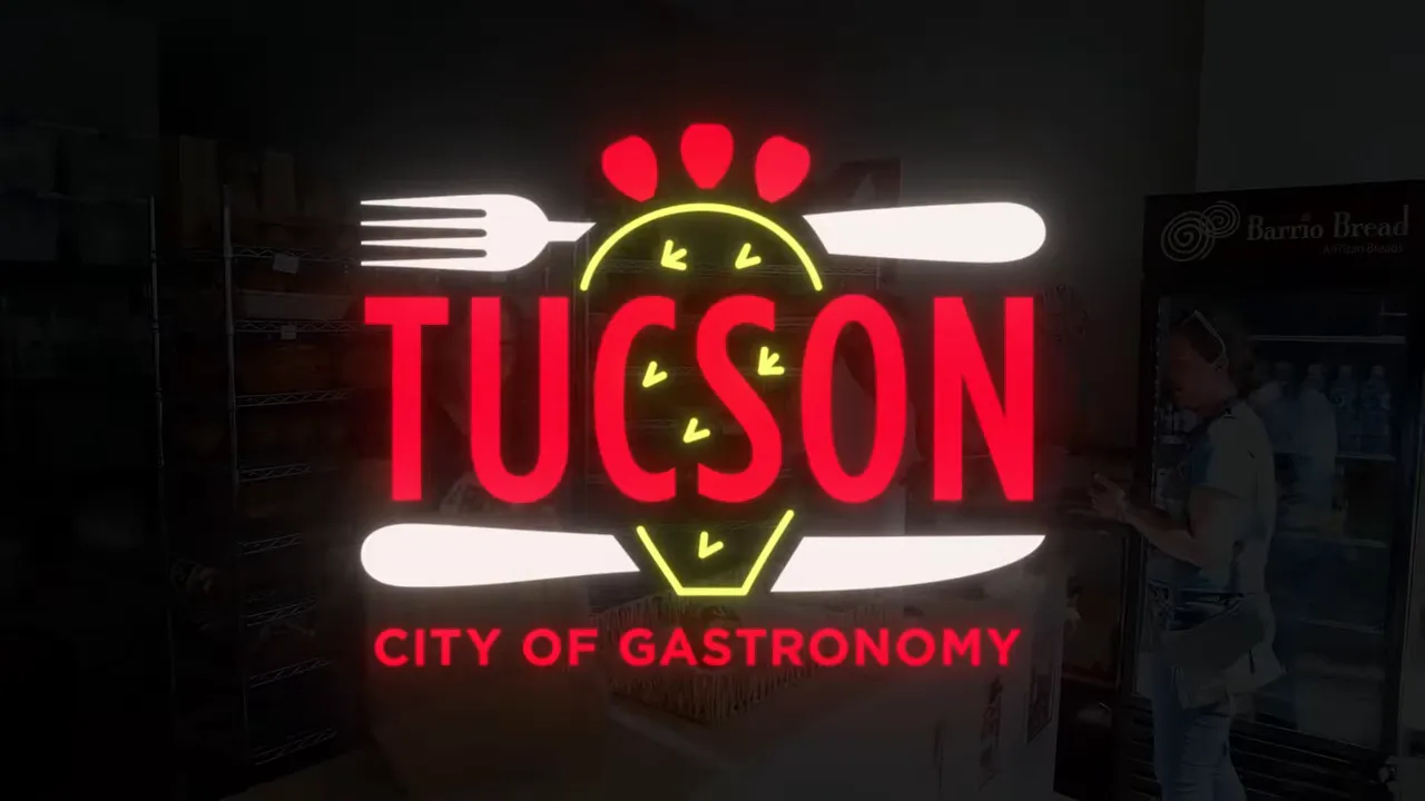 Tucson City of Gastronomy graphic over a restaurant interior