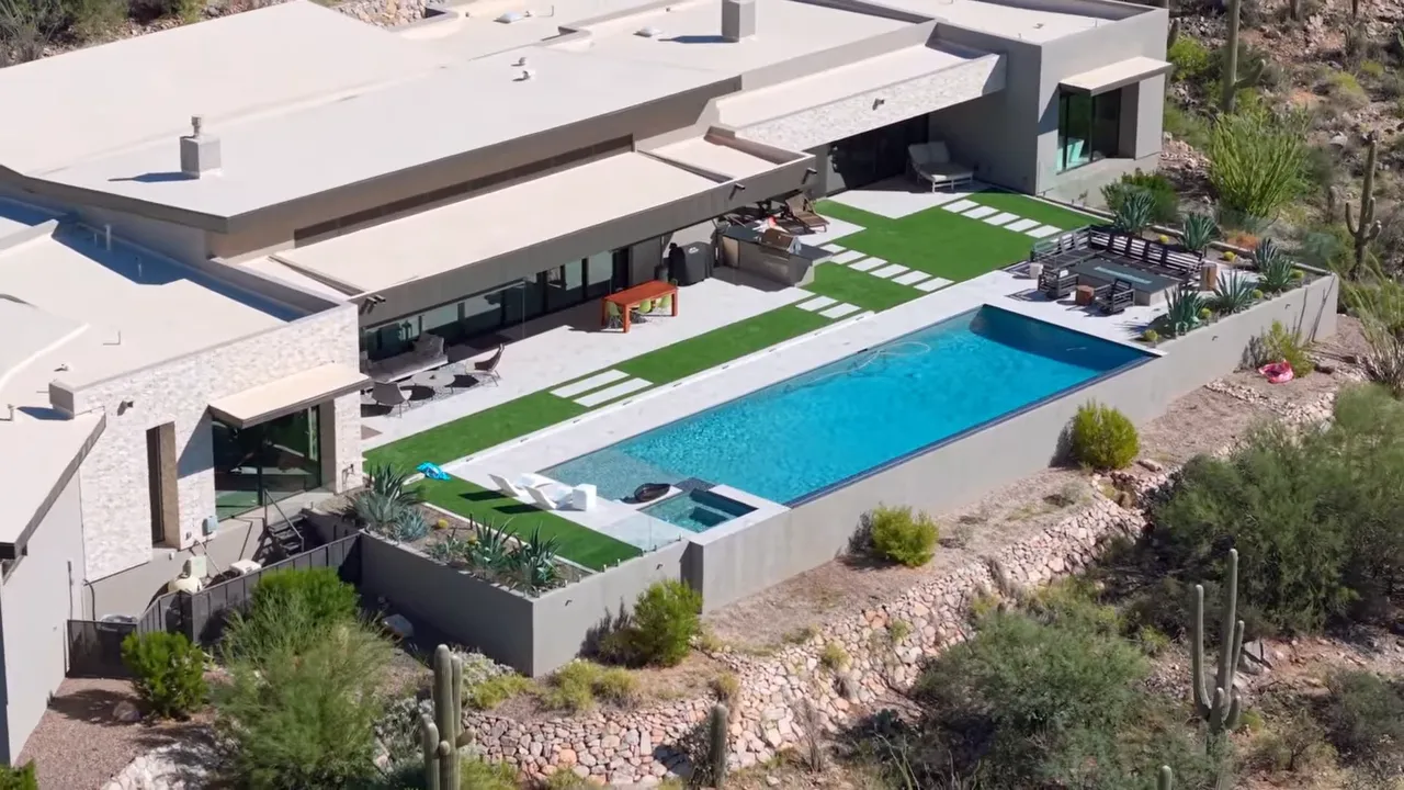 Large contemporary desert home with pool and landscaped patio