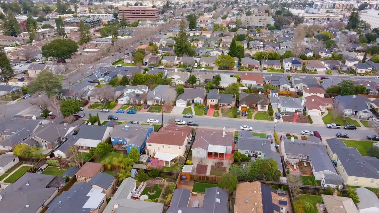 Aerial drone view of suburban neighborhood with houses and streets in San Mateo County