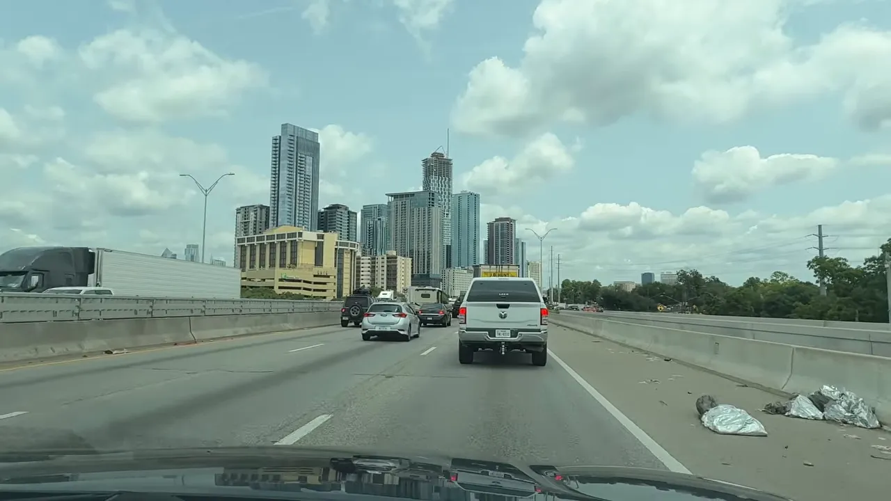 Two cars in driveway representing commuting costs