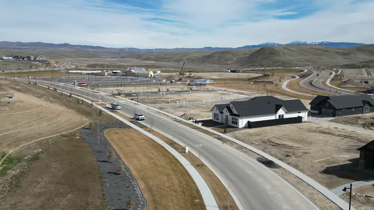 Aerial view of the valnova community construction roads and homes with foothills and mountain views