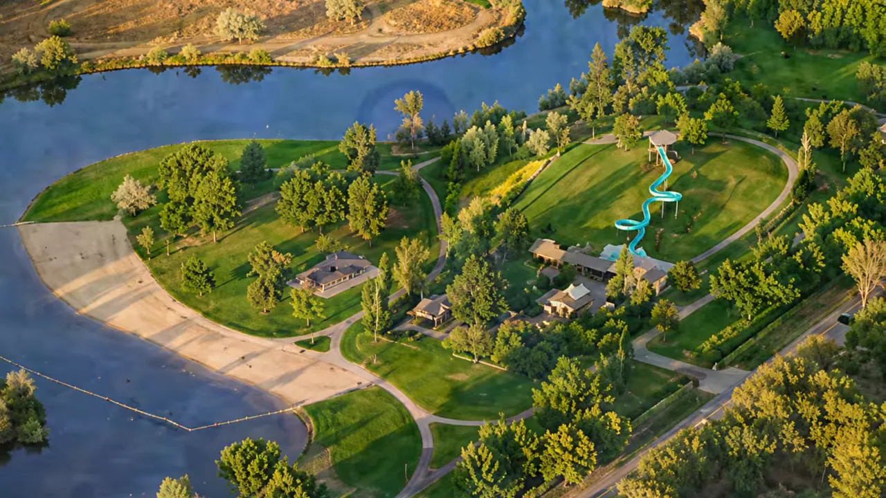 Aerial view of Eagle Island State Park in Eagle, Idaho with paths, trees, and water