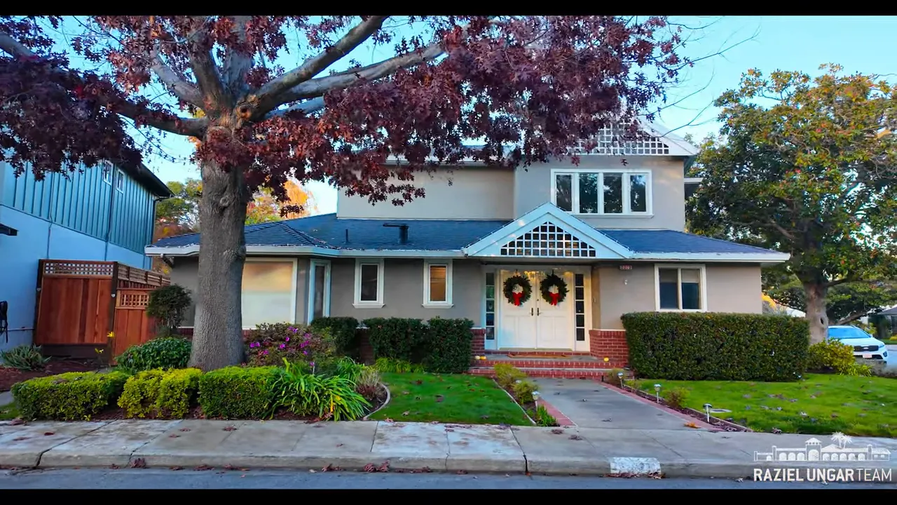 Front exterior of a Burlingame single-family house with a tree-lined yard and walkway