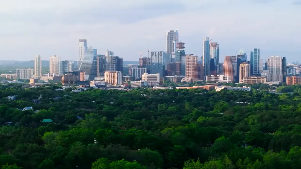 Austin downtown skyline with high-rise buildings above a dense tree canopy