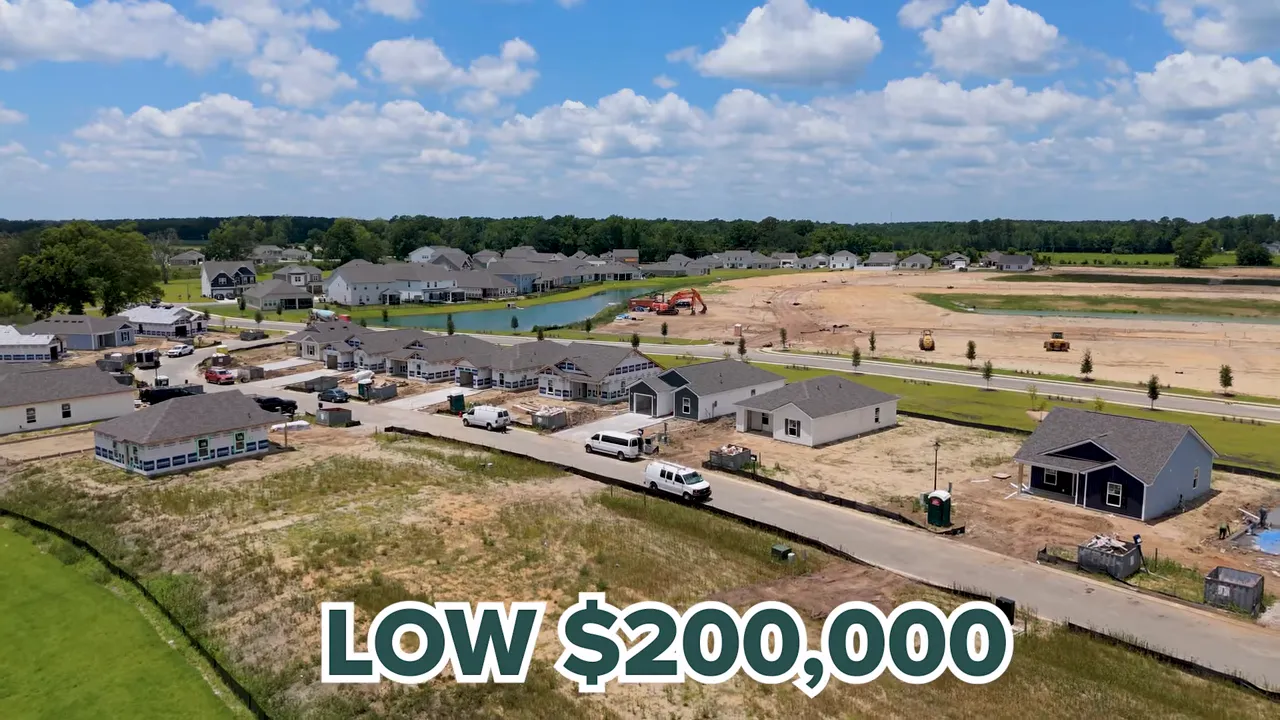 Aerial view of neighborhood construction with low 200000 text on screen