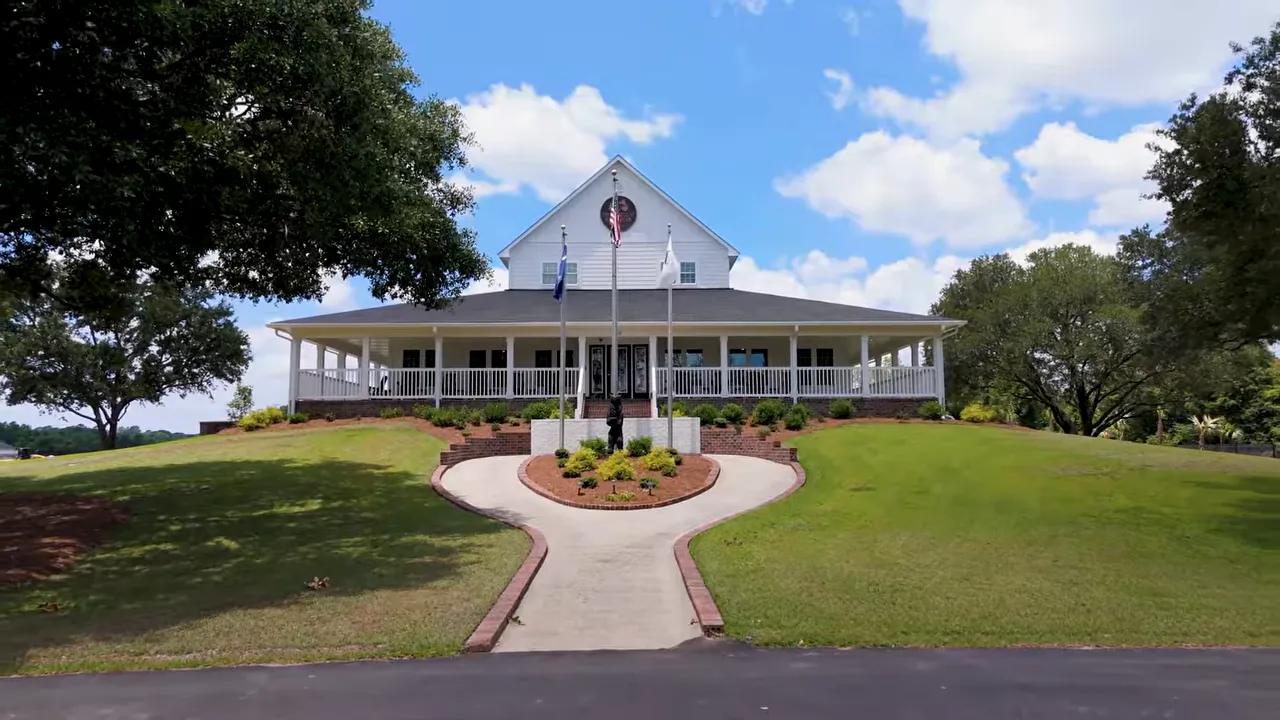 Former golf clubhouse surrounded by lawn and curved walkway