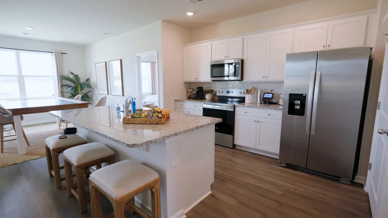 Open kitchen dining area and living room in furnished model home