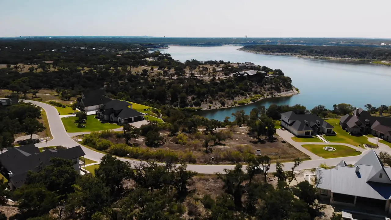 Aerial view of houses and roads along a lake shoreline in Central Texas