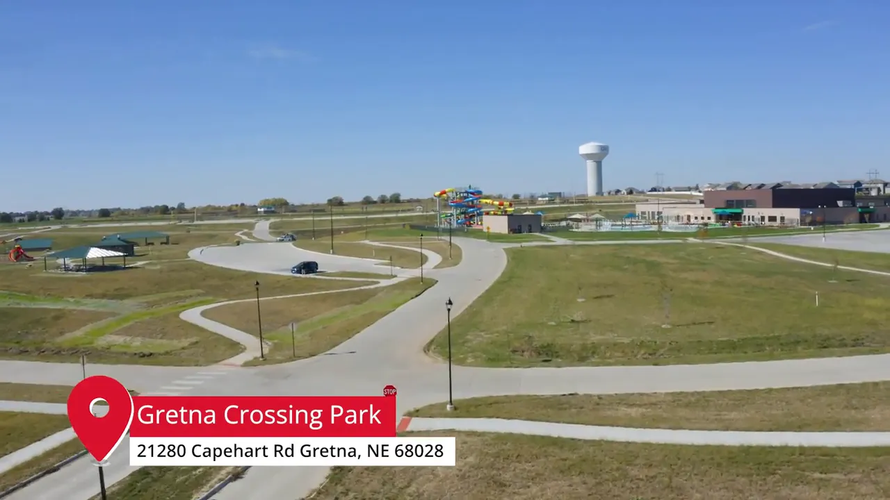 Aerial view of Gretna Crossing Park in Gretna, Nebraska showing paths, playground equipment, and park buildings