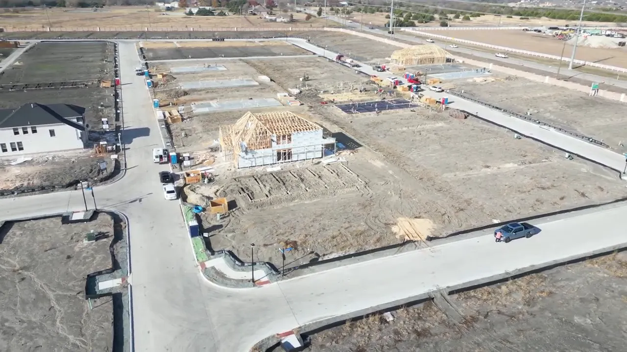Aerial view of new streets home foundations and construction activity
