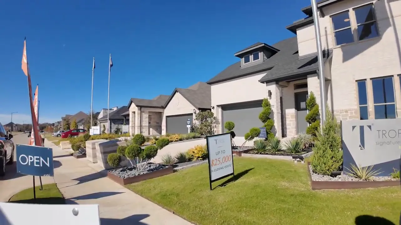 OPEN sign and Trophy model home pricing banner along community walkway in Greenville TX