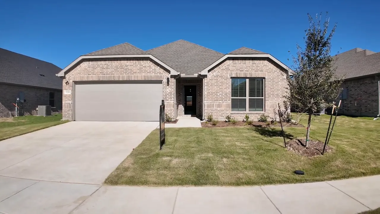 Front exterior view of a new construction home in Greenville TX with garage, walkway, and landscaping