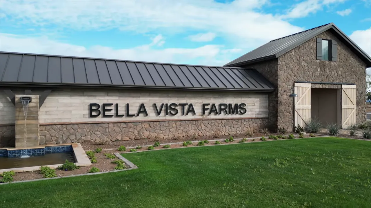 stone entry monument with Bella Vista Farms sign and green lawn