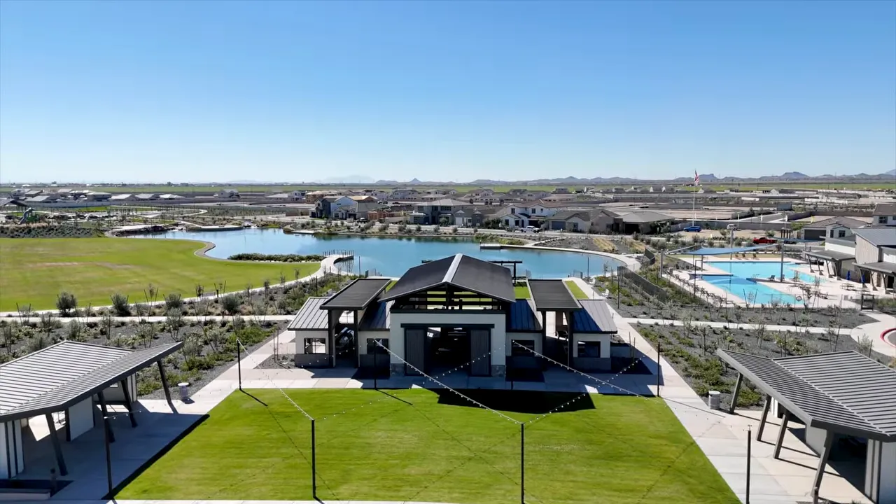 central clubhouse lawn with lake on one side and pool area on the other