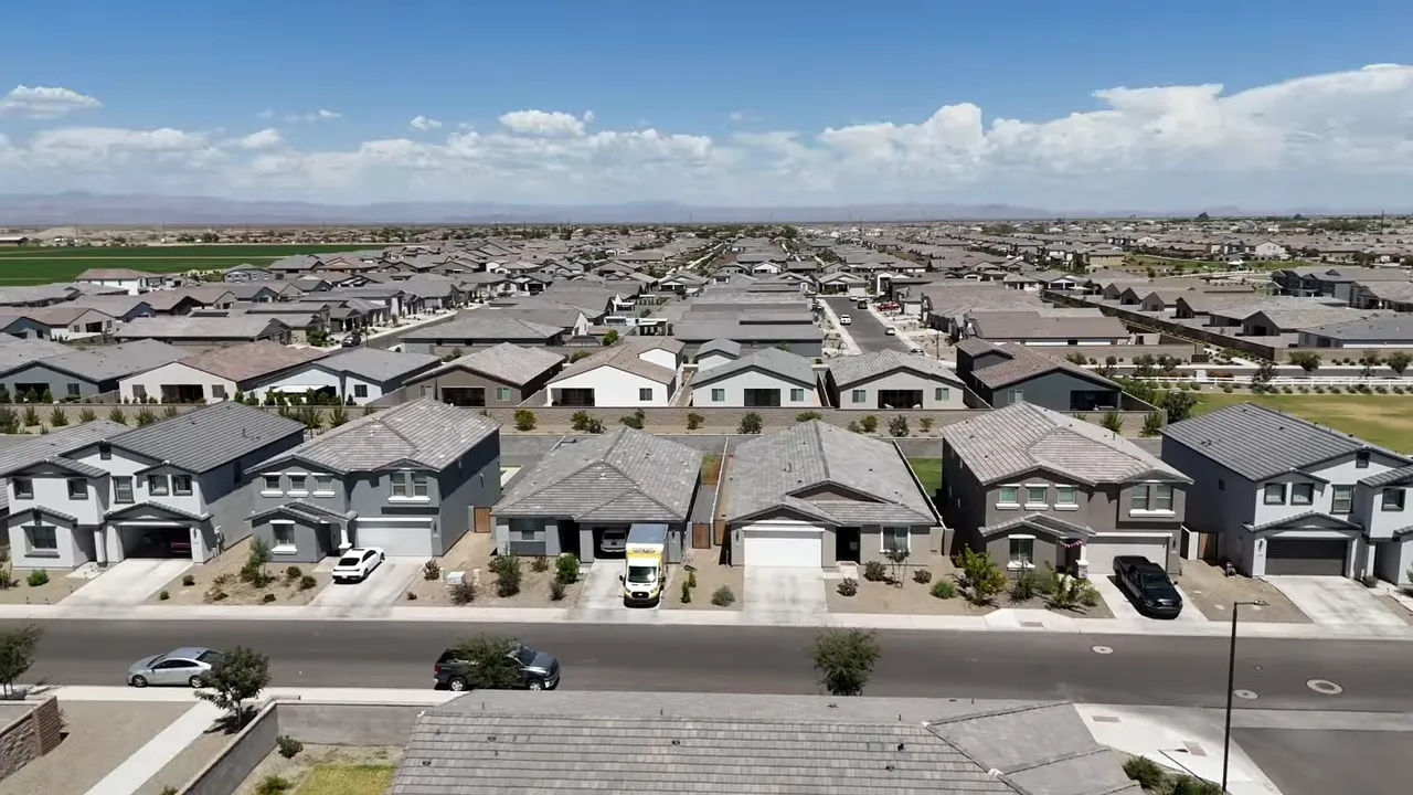 wide aerial view of neighborhood homes streets and surrounding development