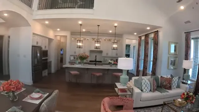 Open living room dining room and kitchen beneath second-floor overlook