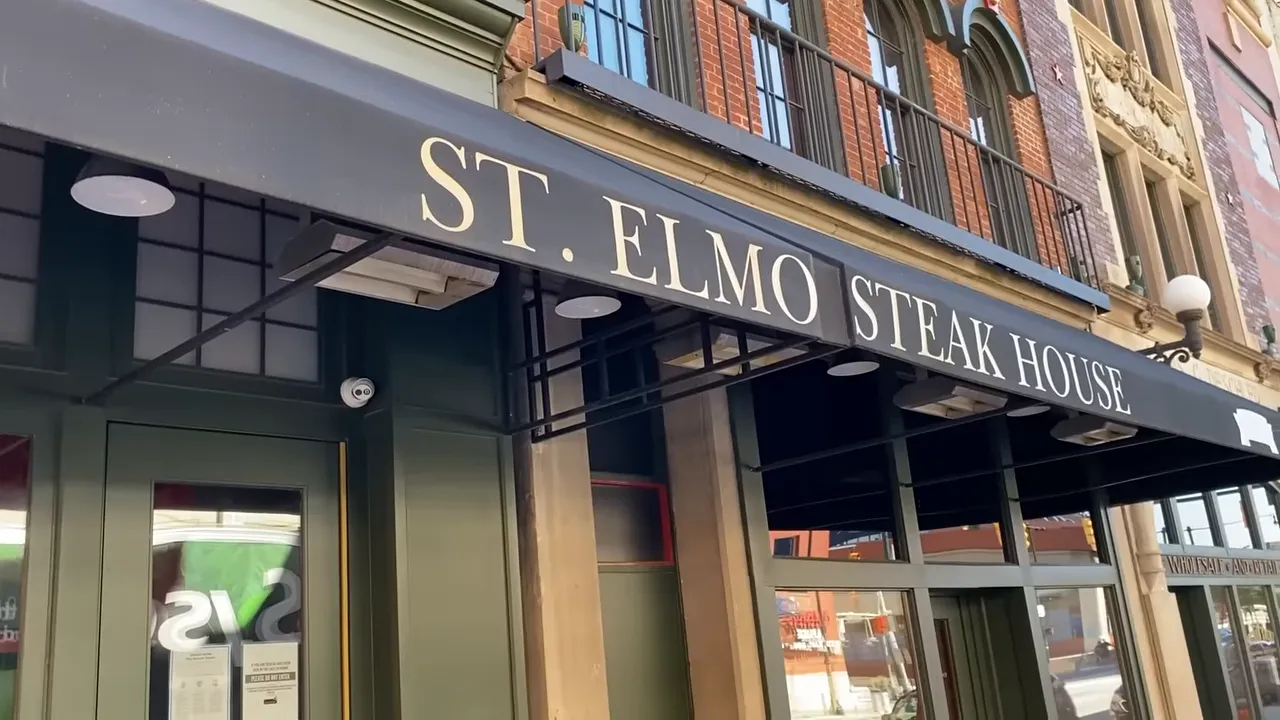 Front awning and entrance of St. Elmo Steak House showing the restaurant name