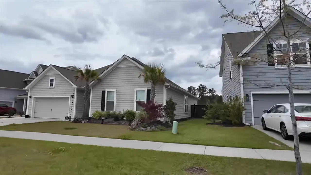 Front yards and houses on a suburban street in Summerville showing sidewalks, driveways, and landscaping
