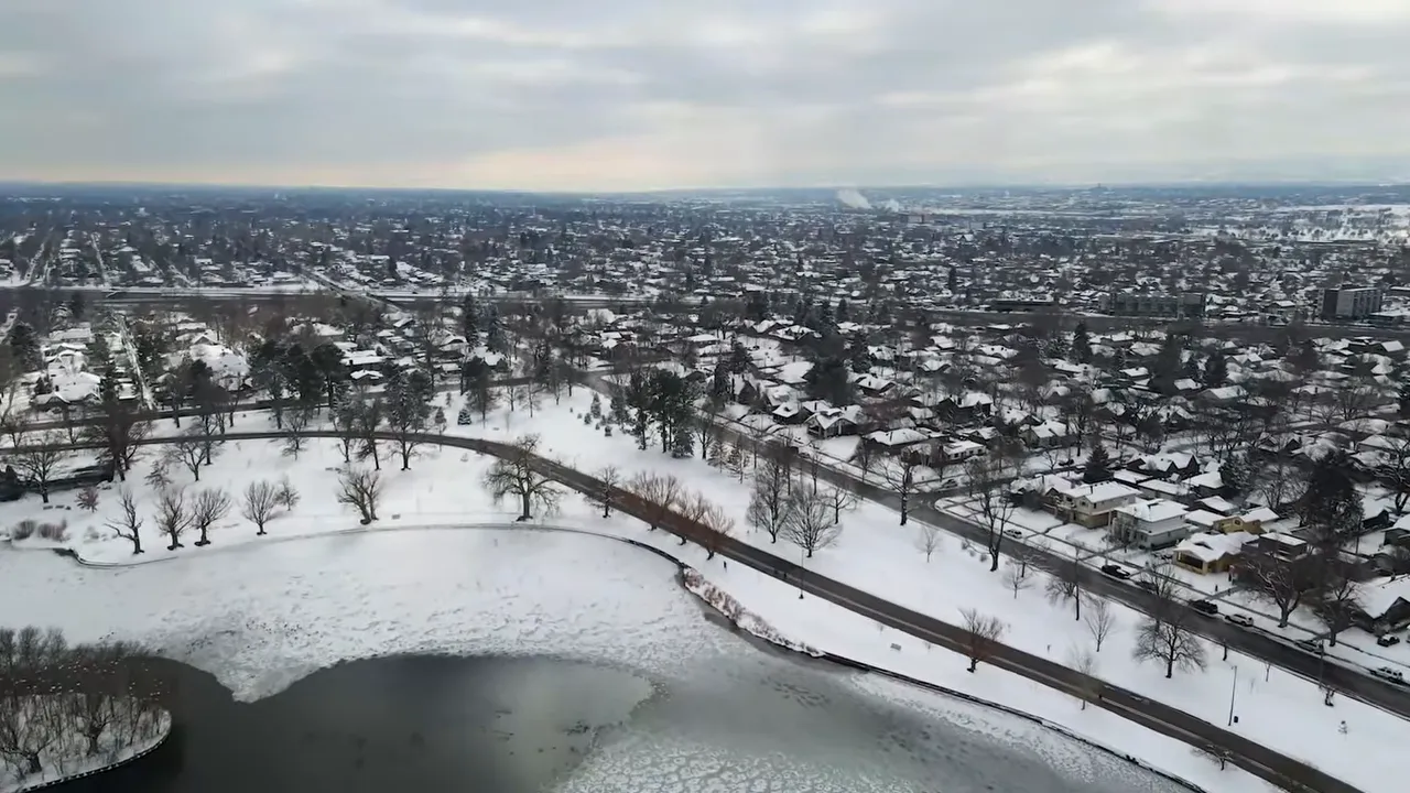 Snow-covered neighborhood in the Denver metro during winter with a river and houses