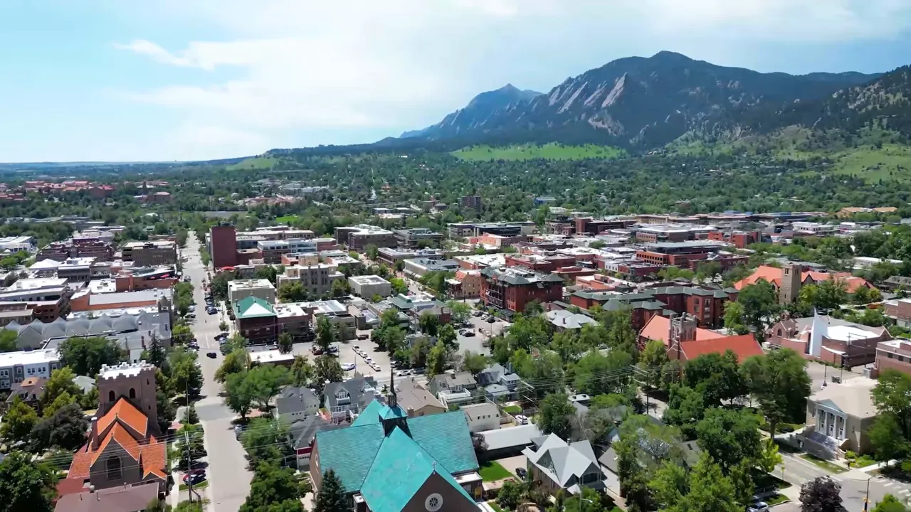 Aerial view of Denver metro neighborhoods with mountain backdrop