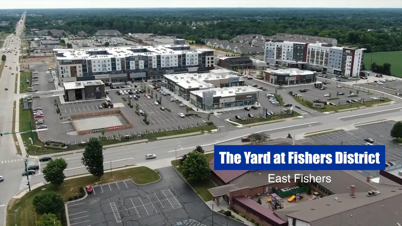 Aerial view of The Yard at Fishers District with shops, apartments, and roads