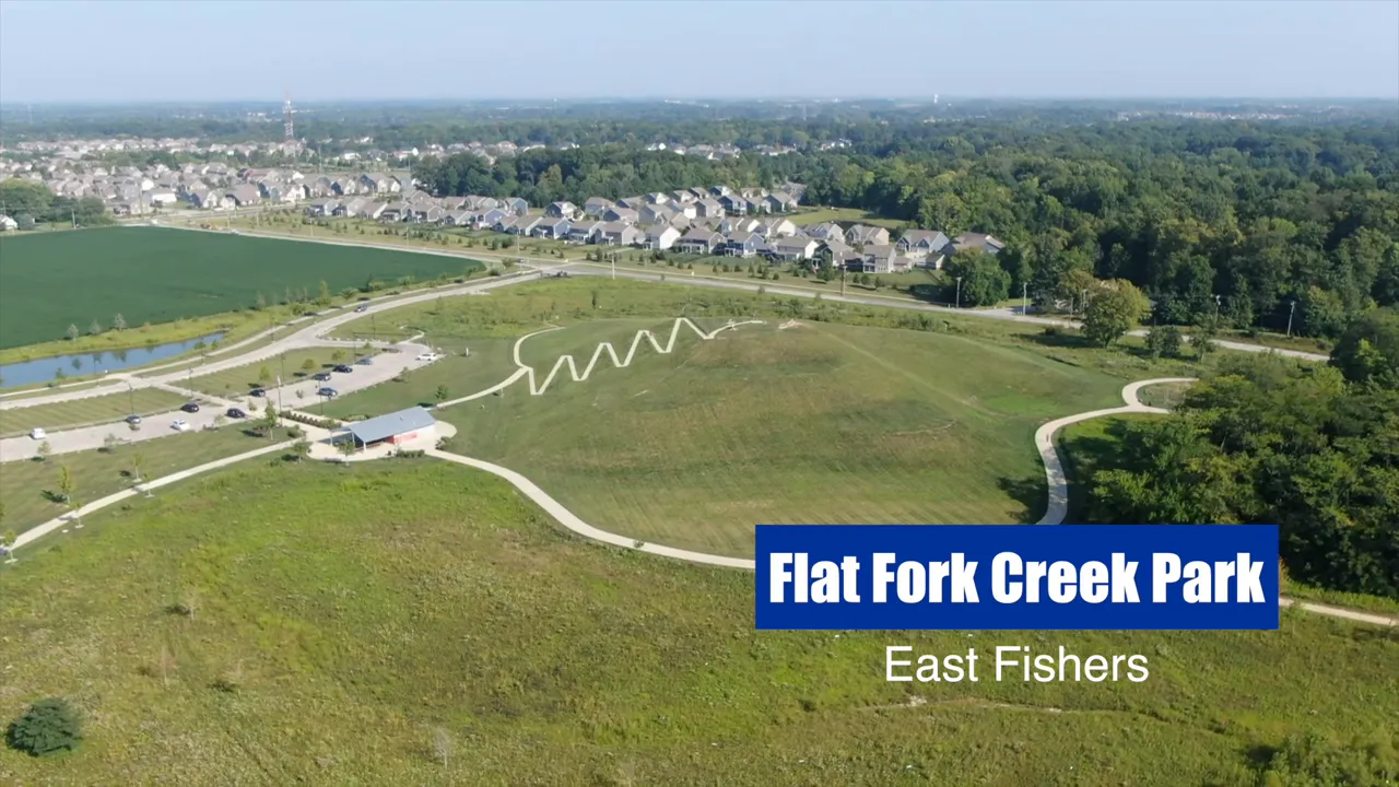 Aerial view of Flat Fork Creek Park with sledding hill trails and nearby neighborhoods