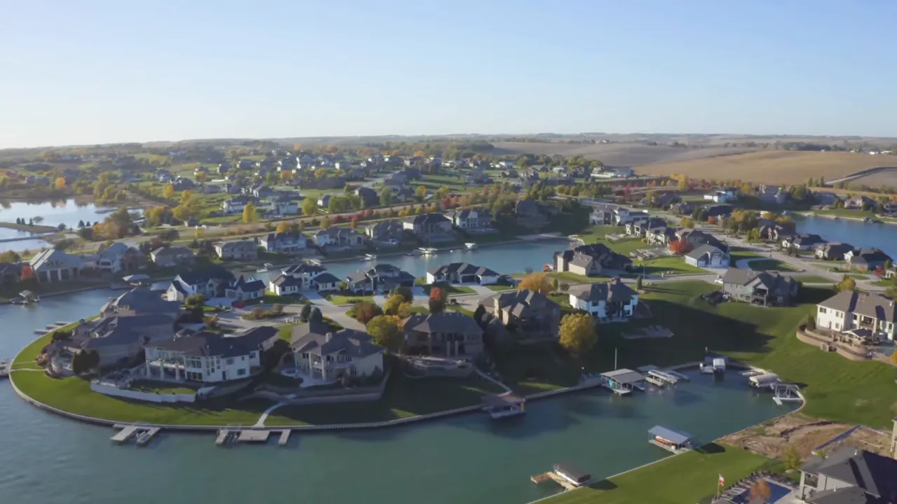 Aerial view of Omaha neighborhood homes near a lake and winding roads