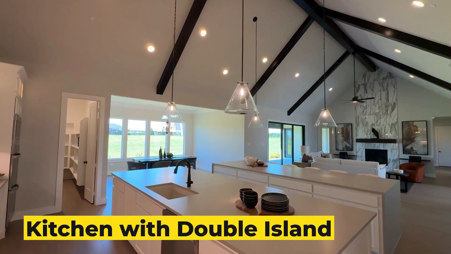 Double island kitchen with shaker cabinets and stainless steel appliances