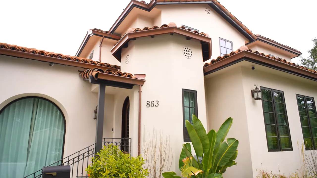 Spanish-style home exterior with number 863 and landscaped front yard in Edgewood Park, Redwood City