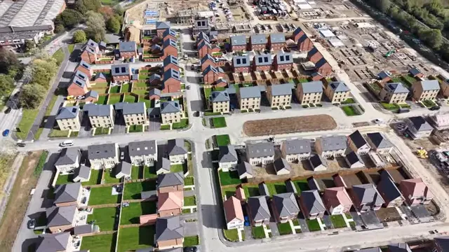 Aerial view of a new master planned neighborhood with streets homes and green spaces