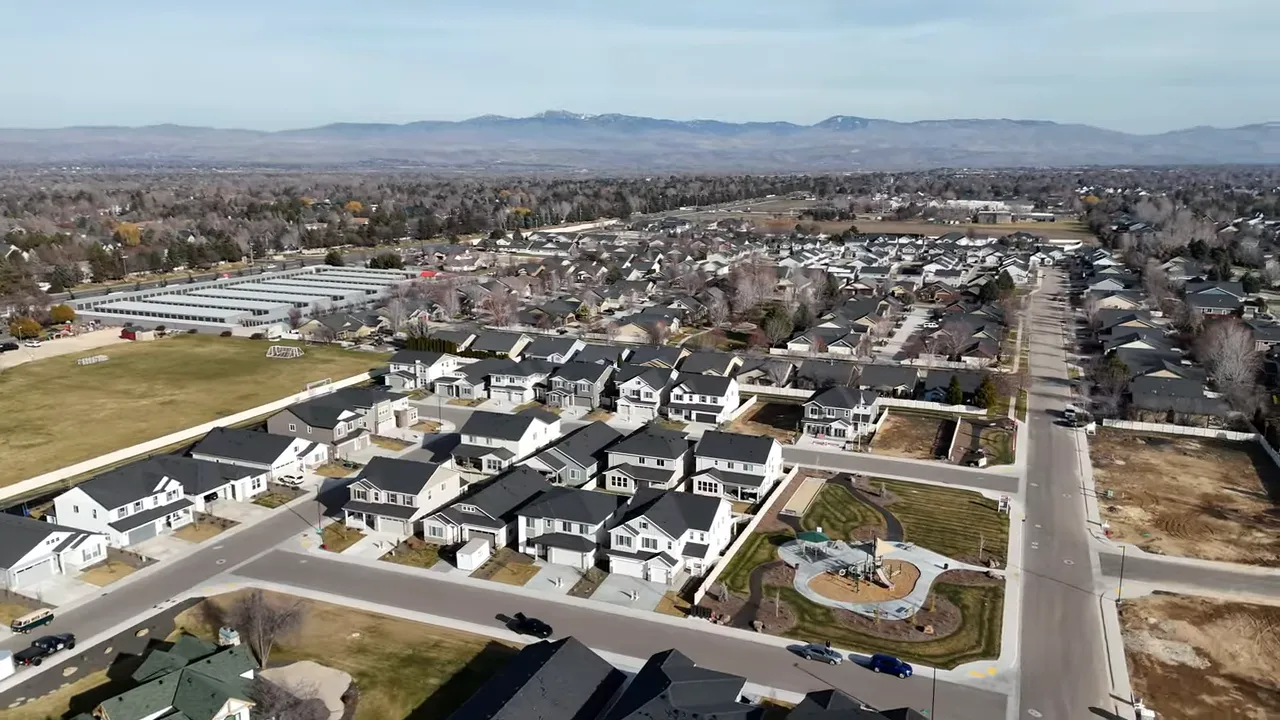 Aerial view of Meridian housing community expansion with wide streets and rooftops