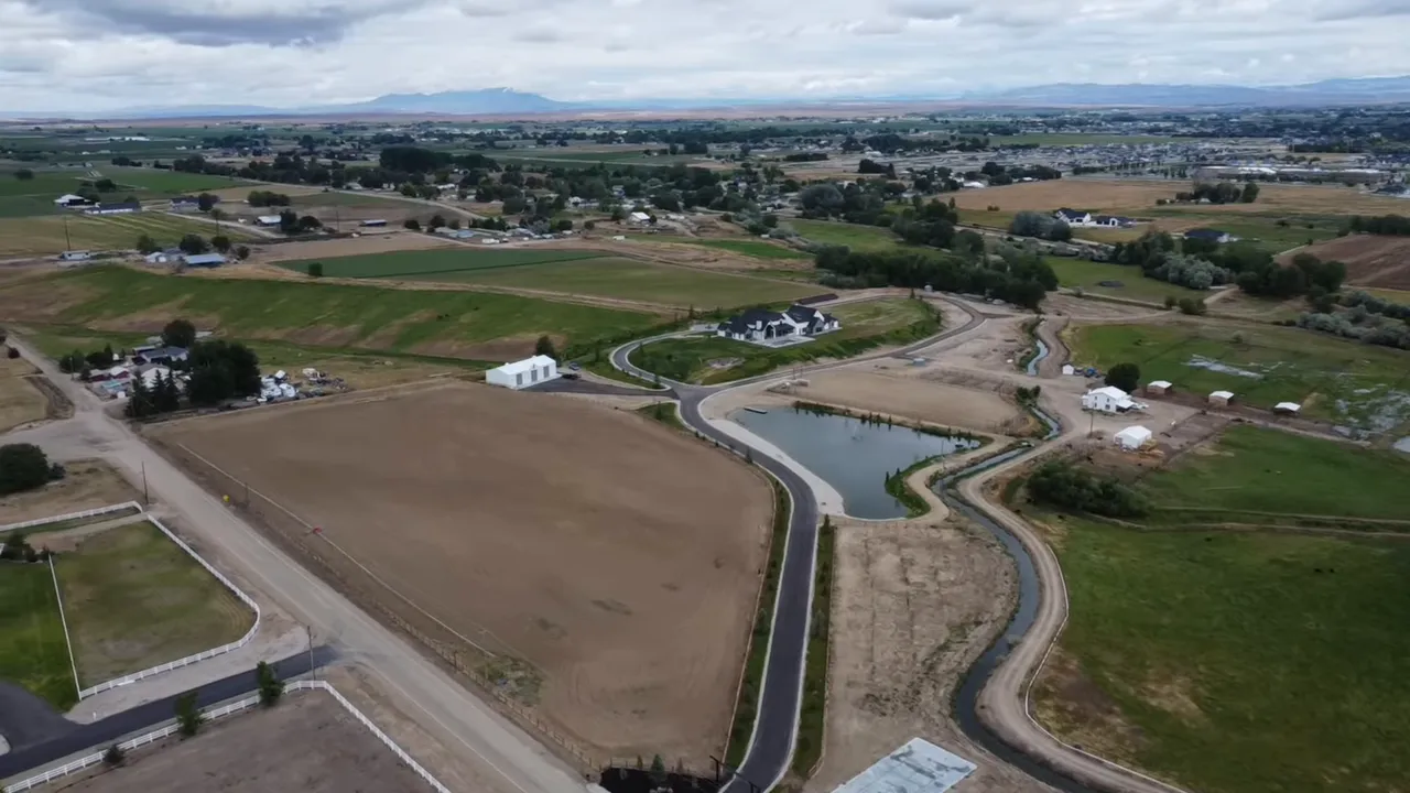 High‑quality aerial view of farmland, roads, ponds, and early subdivisions near Boise