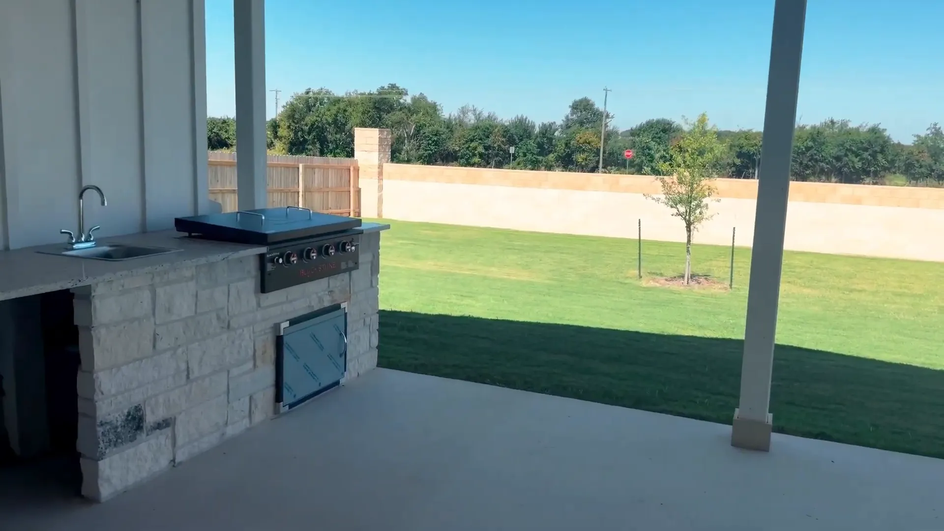 Covered patio with outdoor kitchen and seating area