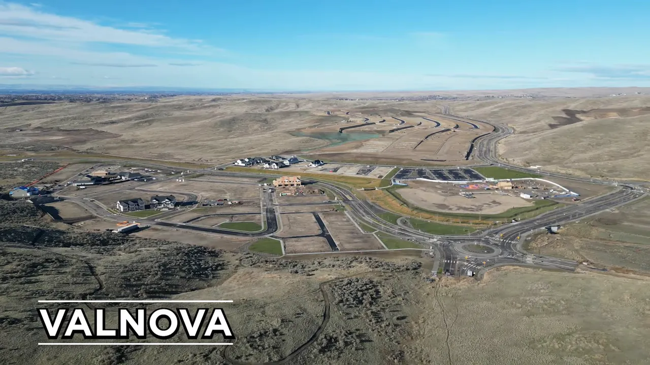 Aerial view of Valnova master-planned community with roads, lots, and rolling foothills