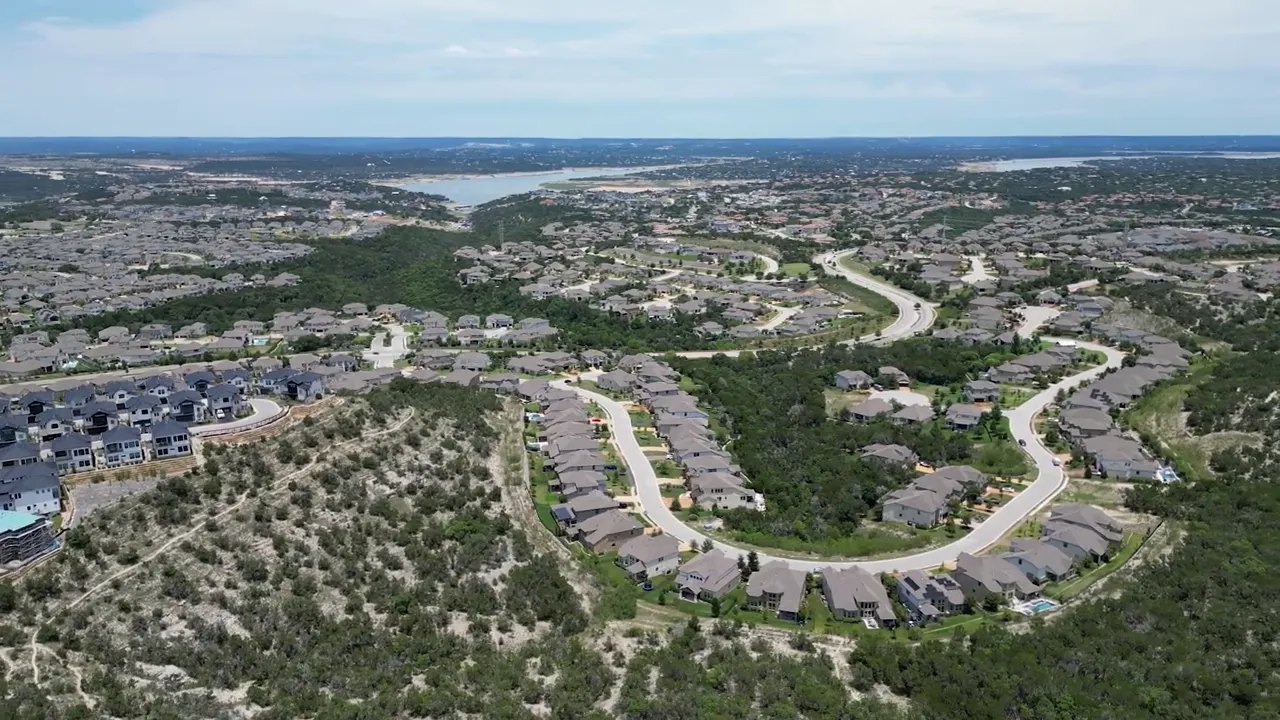 aerial view of luxury homes on large lots in a hilly neighborhood