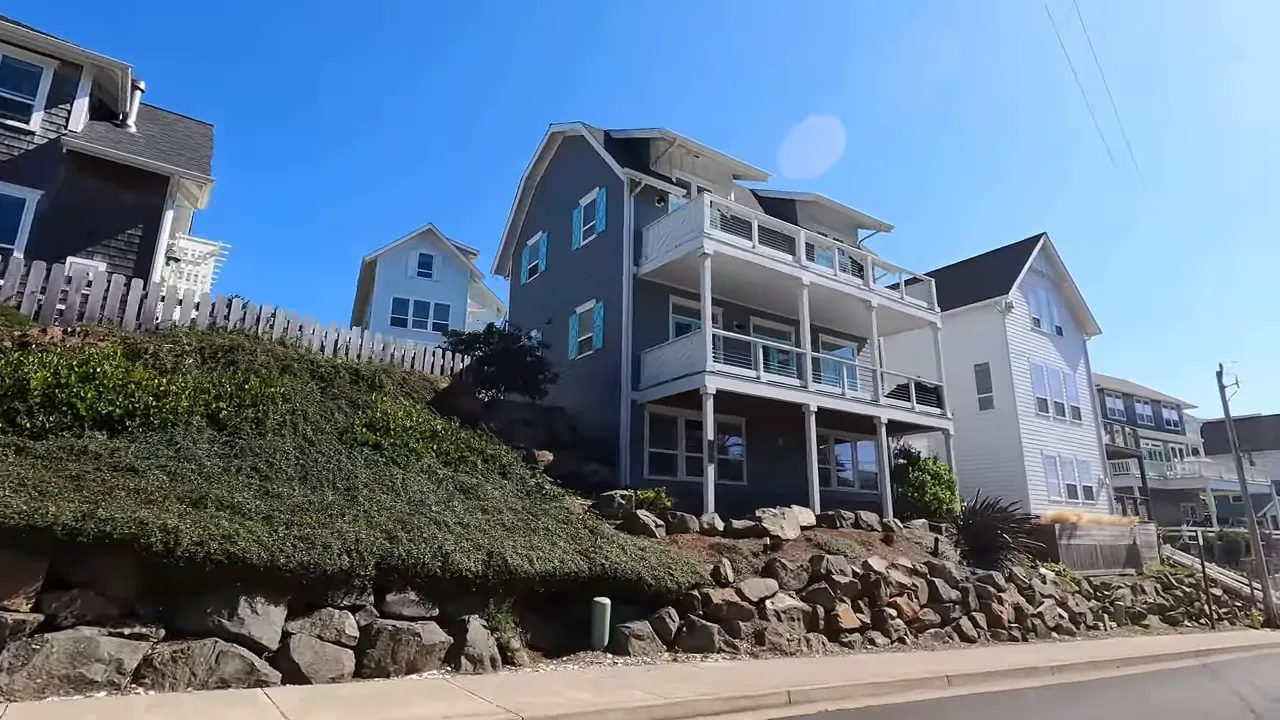 Large multi level coastal homes above rock retaining walls