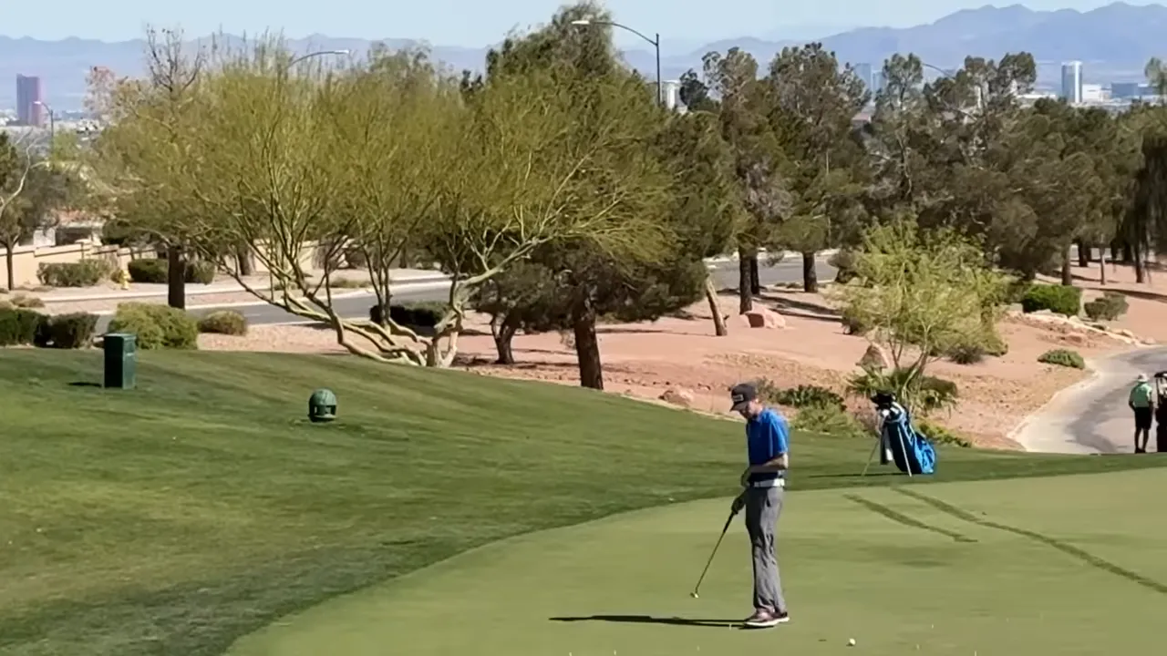 People playing golf beside a clubhouse and a community lounge