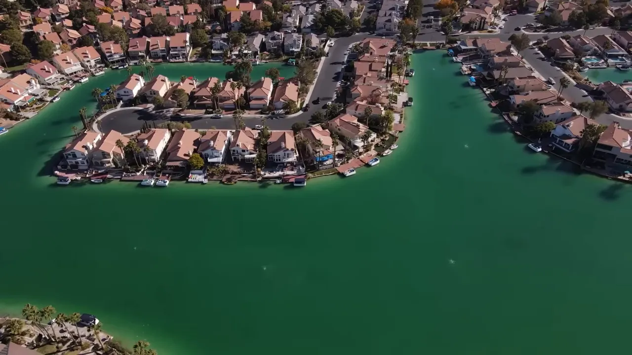 Aerial view of homes surrounding green water at Lake Las Vegas