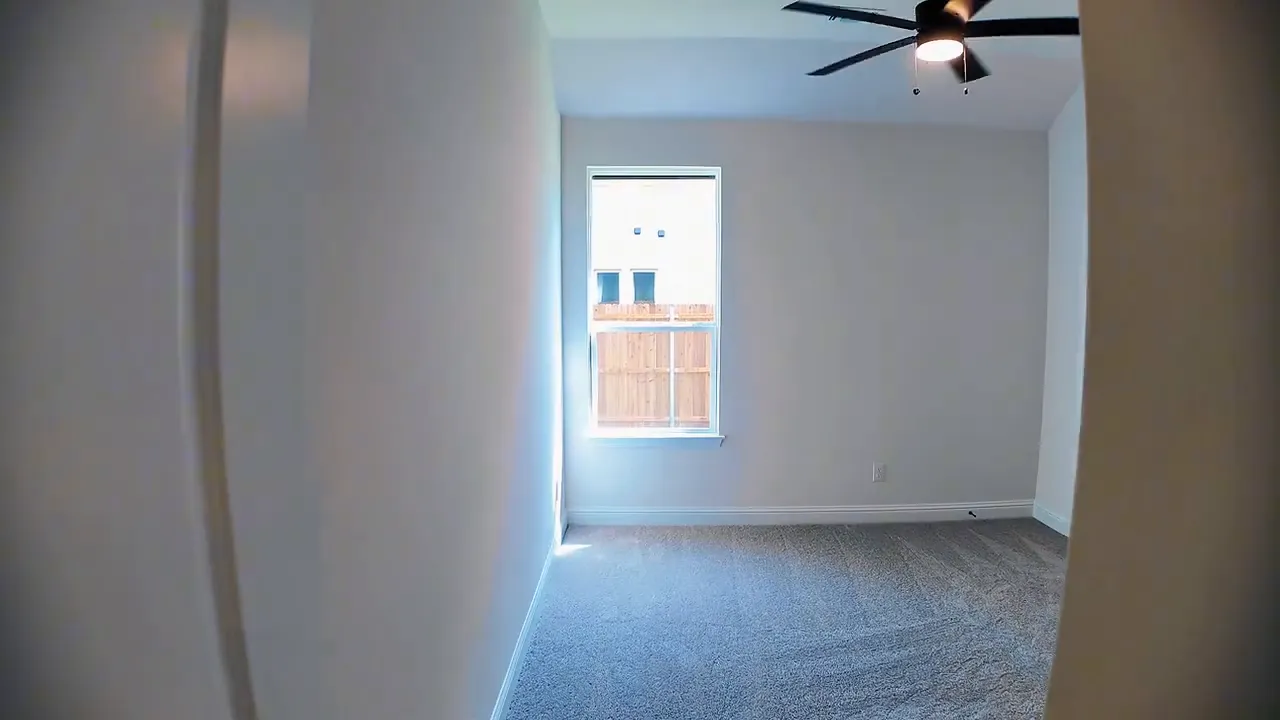 Secondary bedroom with single window ceiling fan and double closet doors