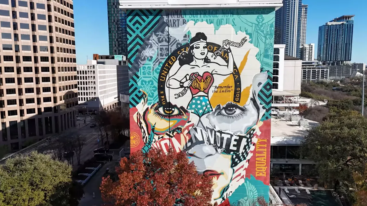 Straight-on drone photo of the Beauty of Liberty and Equality mural covering the side of the Line Hotel in downtown Austin