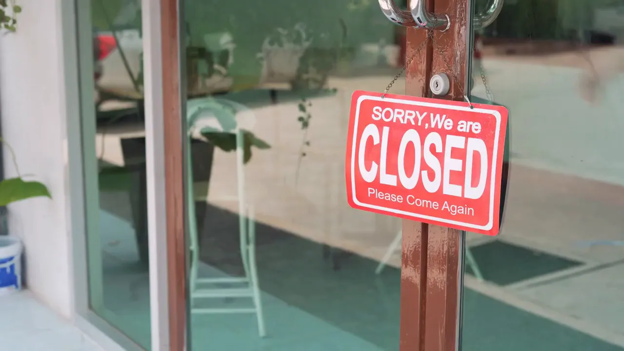 Glass door with a red closed sign