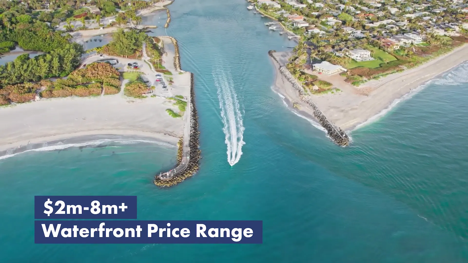 Aerial shot of a boat running through a coastal inlet with jetties and turquoise water, with price-range text overlay